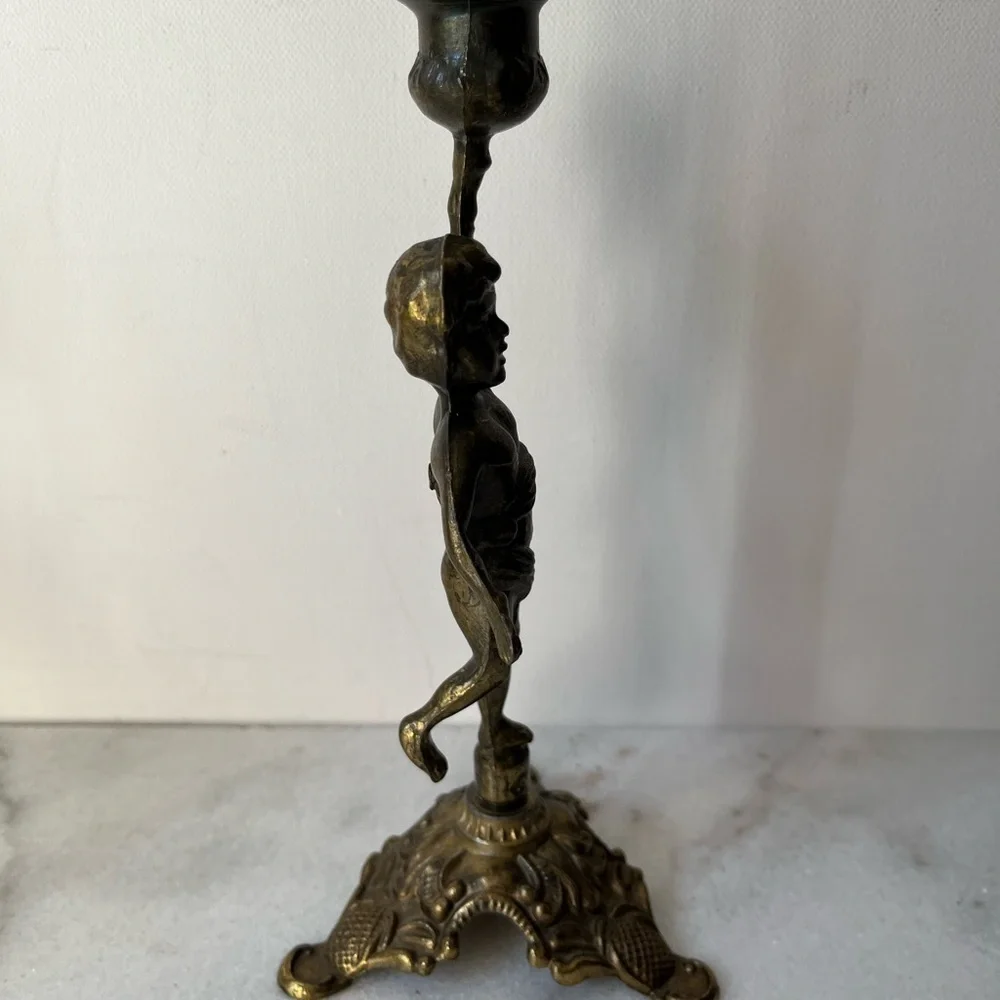 Antique cherub figurine candle holder